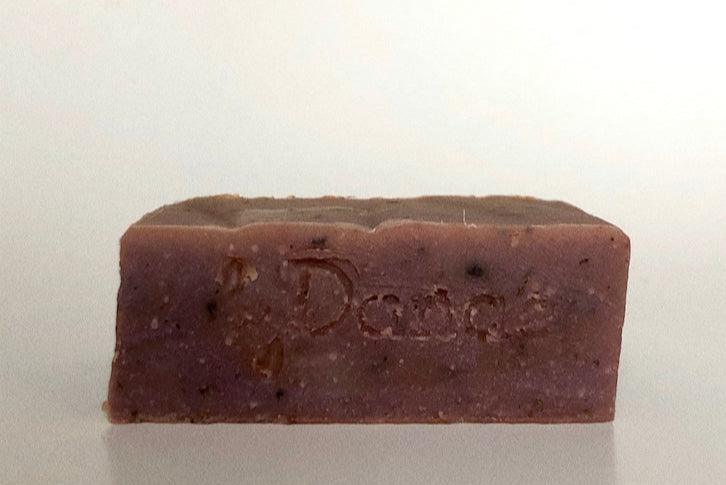 Bar light redish purple soap on a white background representing the beetroot soap